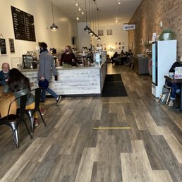 people sitting at tables in a coffee shop people sitting at tables in a coffee shop