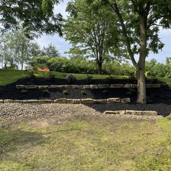 Ryan's Signature Landscaping - a stone retaining wall and a tree - Landscaping Near Me Ryan's Signature Landscaping - a stone retaining wall and a tree - Landscaping Near Me