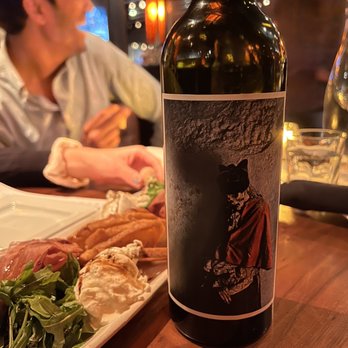Hubbard Grille - a bottle of wine and a plate of food - New American Near Me - Columbus, Ohio