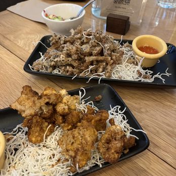 Kati Vegan Thai - Cucumber Vinaigrette Salad (in small white bowl); Angel Wings (middle) and Cauliflower Bombs. - Thai Near Me - Seattle, Washington