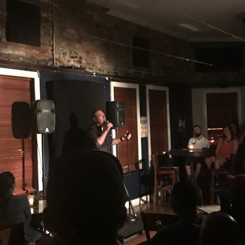 Capital Laughs - a man speaking into a microphone - Comedy Clubs Near Me - Washington, DC, District of Columbia