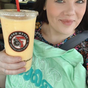 7 Brew Coffee - a woman in a car holding a drink - Coffee & Tea Near Me - Jacksonville, Florida