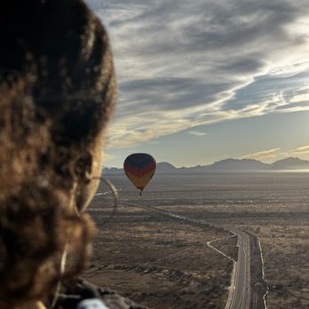 Apex Balloons - My wife looking off into the sun with another hot air balloon in the distance.  The vast mountains, beautiful skies, and long roads. - Hot Air Balloons Near Me - Phoenix, Arizona