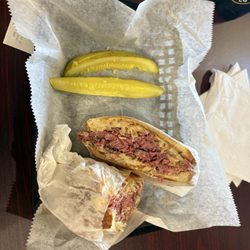 Corned beef Ruben sandwich, comes with pickles