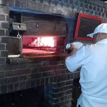 Juliana's - Man in action. - Pizza Near Me - Brooklyn, New York Juliana's - Man in action. - Pizza Near Me - Brooklyn, New York