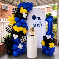 Dazzle Decor NYC - Luxury One Cool Dude first birthday setup with premium balloons, custom signage, and cake pedestal.