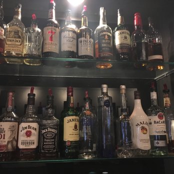 Bushwood lounge - a shelf full of liquor bottles - Lounges Near Me - Omaha, Nebraska Bushwood lounge - a shelf full of liquor bottles - Lounges Near Me - Omaha, Nebraska