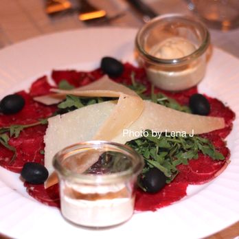 Boscaiola - Carpaccio di Manzo (48 zł) - Beef carpaccio with rocket, Grana Padano and black olives - Italian Near Me - Kraków, Massachusetts