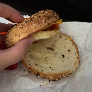 Dunkin' - a person holding a bagel sandwich - Donuts Near Me - Fitchburg, Massachusetts Dunkin' - a person holding a bagel sandwich - Donuts Near Me - Fitchburg, Massachusetts