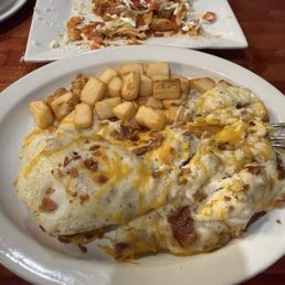 Jalapeño cornbread sausage gravy with two eggs and potatoes.