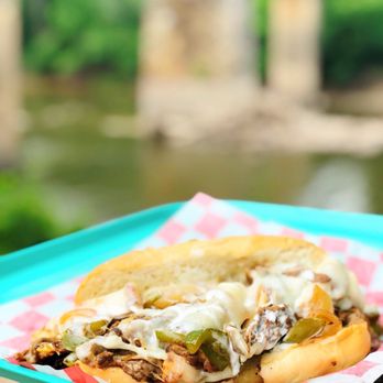 Deep Creek Grill - a pulled pork sandwich on a paper plate - Burgers Near Me - Fayetteville, North Carolina Deep Creek Grill - a pulled pork sandwich on a paper plate - Burgers Near Me - Fayetteville, North Carolina