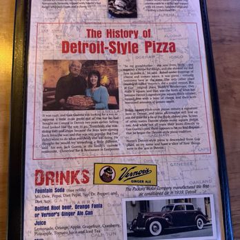 Norm's Wayside - Menu, spicey green beans, onion rings, all meat Detroit style pizza and in and out burger. - The menu page displays sections for desserts, drinks, and the history of Detroit-style pizza. It features a photo of two people with a pizza, a vintage car image, and a logo for Vernor's Ginger Ale. The dessert section mentions a fudge brownie and PiZookie, while the drinks section lists fountain soda, bottled root beer, orange Fanta, and ginger ale. The history section provides background on the restaurant's origins, with a focus on its Detroit-style pizza and its connection to local history. The layout includes images, text, and branding elements, all set against a background map. - Pizza Near Me - Buffalo, Minnesota