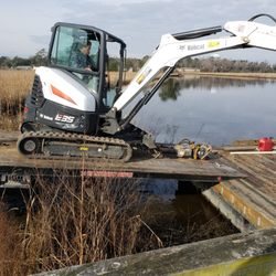Herbie's Towing Service - UNLOADING EXCAVATOR ON BARGE
