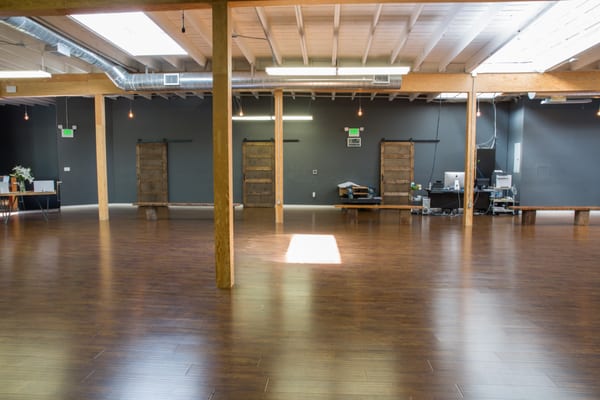 Photo of OneTaste - San Francisco, CA, US. Main room with Barn Door storage spaces