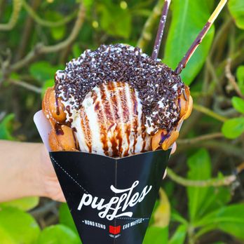 Puffles - a hand holding a cone of ice cream - Ice Cream & Frozen Yogurt Near Me - Miami, Florida