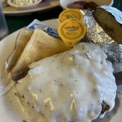 Bass Haven Restaurant - Country fried steak with an over cooked potato. Butter and sour cream