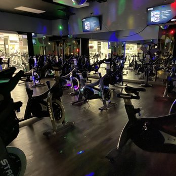 Hourglass Women's Wellness - Spin Class room is amazing with the strobes/speakers/TV's & check out the disco ball ! Makes the classes funner with that nightclub vibe !! - Aerial Fitness Near Me - White Plains, New York