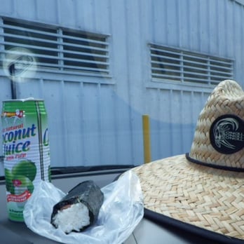 Menehune Food Mart - a straw hat on a car - Beer, Wine & Spirits Near Me - Kekaha, Hawaii