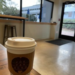 a cup of coffee on a table a cup of coffee on a table