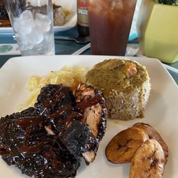 Jerk chicken, rice and beans, plantains, steamed cabbage. Pineapple iced tea ‍