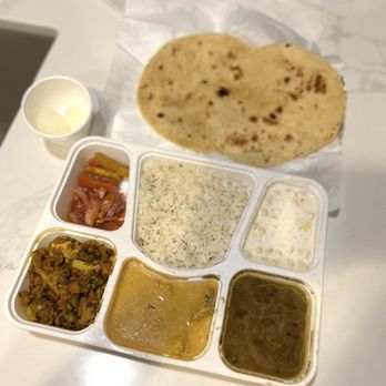 Indian Supermarket - Monday 1.22.24 thali: (clockwise) chapati, jeera rice, raita, daal tadka, malai kofta, veg & paneer, veg pickles, maybe rasgulla - Indian Near Me - Sacramento, California
