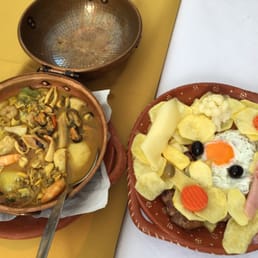 Seafood stew and a steak dish with chips and a fried egg. Amazing, flavorful dishes!