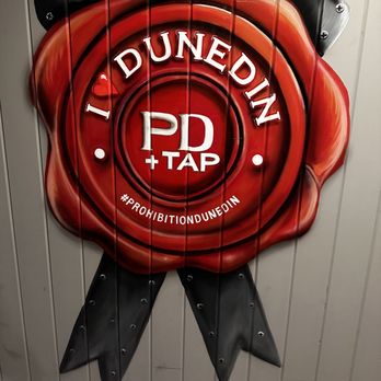 Prohibition Dunedin - a red wax seal on a wall - Gastropubs Near Me - Dunedin, Florida