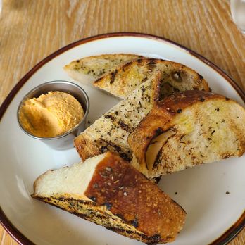 Plori Restaurant - Complementary bread with oil, seasoning, and a side of tirokafteri - Greek Near Me - Carle Place, New York