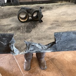 Side view of broken drip tray with broken part. Side view of broken drip tray with broken part.