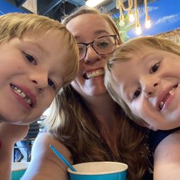 a woman and two children taking a selfie a woman and two children taking a selfie
