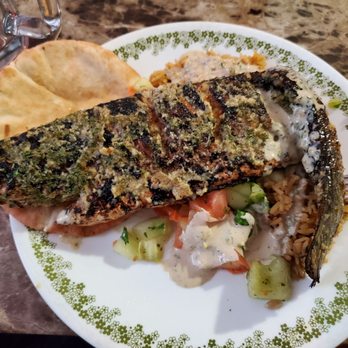 Samakmak Seafood - Blackened branzino atop rice, tomato/cucumber/mint, and pita with tahini - Mediterranean Near Me - Jersey City, New Jersey Samakmak Seafood - Blackened branzino atop rice, tomato/cucumber/mint, and pita with tahini - Mediterranean Near Me - Jersey City, New Jersey