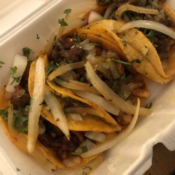 Tacos El Carrito - Al pastor tacos topped with onions, cilantro, lime, radish, and hot sauce.