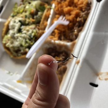 Chiva Coco - a hand holding a fork in front of a tray of food - Mexican Near Me - Rialto, California