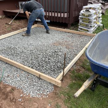 Lavish Gardens NJ - a man pouring concrete in a backyard - Landscaping Near Me Lavish Gardens NJ - a man pouring concrete in a backyard - Landscaping Near Me