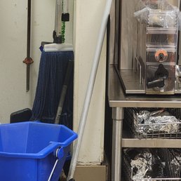 Mop station next to brewed ice coffee with no lid Mop station next to brewed ice coffee with no lid