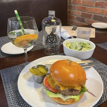 McSwiggan's - McSwiggen's burger, side Caesar salad, Lavender gin and tonic and chilled bottled water in glass container - Irish Pub Near Me - Weymouth, Massachusetts McSwiggan's - McSwiggen's burger, side Caesar salad, Lavender gin and tonic and chilled bottled water in glass container - Irish Pub Near Me - Weymouth, Massachusetts