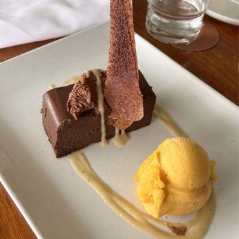 Shore - Chocolate cake with mango sorbet on the side (delicious dessert but the cake was more of a fudge texture) - New American Near Me - Longboat Key, Florida