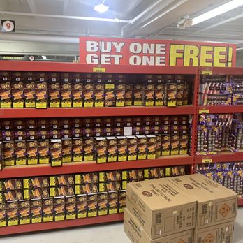 TNT Fireworks Dania Beach - Clearly sitting on the top of this two sided rack. In the middle of an isle. With the same items back to back. BOGO FREE!!! - Fireworks Near Me - Dania Beach, Florida TNT Fireworks Dania Beach - Clearly sitting on the top of this two sided rack. In the middle of an isle. With the same items back to back. BOGO FREE!!! - Fireworks Near Me - Dania Beach, Florida