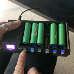 Smoke World Vape - Three batteries on the left from vape shop, only one taking a charge