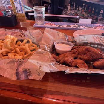 Rooster's - Full Order of Hand Breaded Fried Fingers tossed in Medium Sauce with a side of Ranch and Curly Fries. - Chicken Wings Near Me - Bowling Green, Kentucky Rooster's - Full Order of Hand Breaded Fried Fingers tossed in Medium Sauce with a side of Ranch and Curly Fries. - Chicken Wings Near Me - Bowling Green, Kentucky