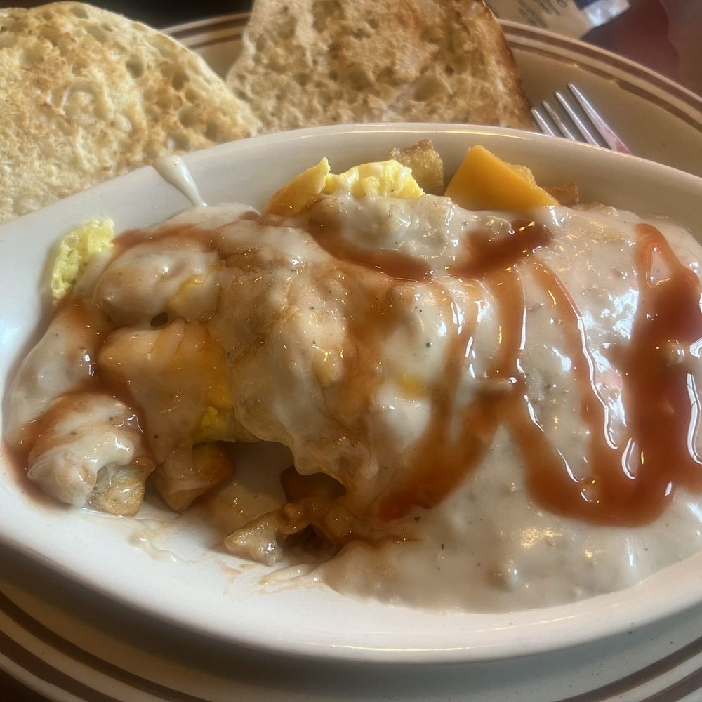Fried home-fries, scrambled eggs, cheese & topped with sausage gravy. I added some hot sauce! English muffin instead of toast. Fried home-fries, scrambled eggs, cheese & topped with sausage gravy. I added some hot sauce! English muffin instead of toast.