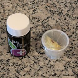 Movita Juice Bar - Activated Charcoal Shot. Comes with a slice of pineapple