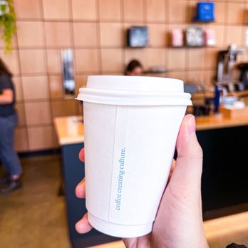 Nemesis Coffee - a hand holding a cup of coffee - Bakeries Near Me - North Vancouver, British Columbia Nemesis Coffee - a hand holding a cup of coffee - Bakeries Near Me - North Vancouver, British Columbia