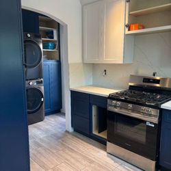 Colorful Kitchen & Bath - Blue and white shaker kitchen with stone countertop
