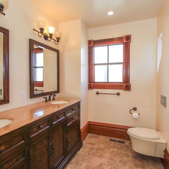 Urban Builders & Remodeling - a bathroom with a toilet, sink, and mirror - General Contractors Near Me - San Jose, California Urban Builders & Remodeling - a bathroom with a toilet, sink, and mirror - General Contractors Near Me - San Jose, California
