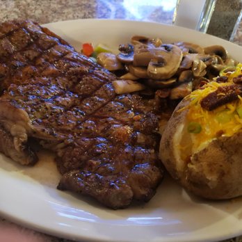 Ale's Steakhouse & Bar - Ribeye steak with sautéed mushrooms and baked potatoe. - Seafood Near Me - Ridgecrest, California