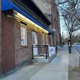 a brick building with a blue awning a brick building with a blue awning