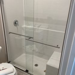 AleksFix - Sliding glass shower door and toilet installation. Clean alignment, secure mounting, and professional finish.