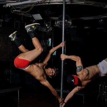 Marty's Live - two men performing a pole dance - Gay Bars Near Me - Dallas, Texas