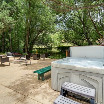 Blue Spruce Caboose - Back patio with hot tub, creek and fire pit -- accessible to rentals - Bed & Breakfast Near Me - Cascade-Chipita Park, Colorado Blue Spruce Caboose - Back patio with hot tub, creek and fire pit -- accessible to rentals - Bed & Breakfast Near Me - Cascade-Chipita Park, Colorado